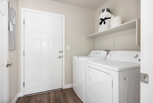 a laundry room with a washer and dryer at The Alloy at Geneva, Vineyard, Utah