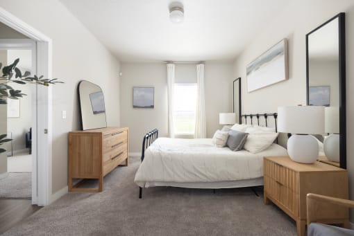 a bedroom with a bed and dresser at The Alloy at Geneva, Utah, 84058