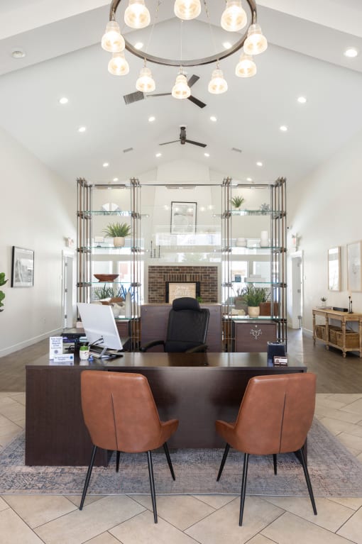 a view of the reception desk with a fireplace in the background and a living room in the at The Alloy at Geneva, Vineyard, UT, 84058