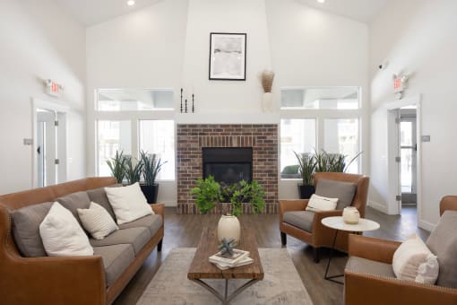 a living room with white walls and a brick fireplace at The Alloy at Geneva, Vineyard, UT