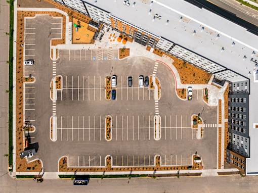 An aerial view of a parking lot with cars parked in it at The Beaumont Apartments, Bozeman, MT