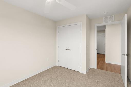 A room with a white door and carpeted floor at The Beaumont Apartments, Bozeman, 59715