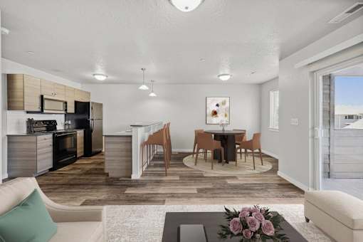 a living room and dining room with a table and chairs