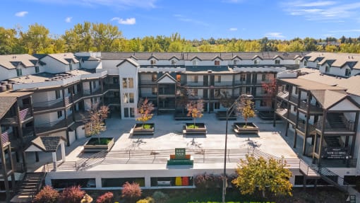 an aerial view of an apartment complex with trees in the background at River Walk Apartments, Boise