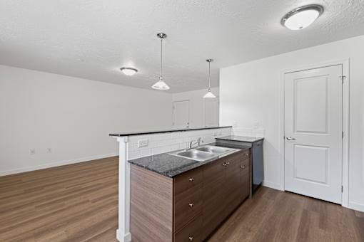 A kitchen with a sink and a counter.