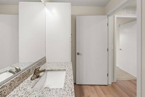 A bathroom with a sink and a mirror at The Beaumont Apartments, Montana