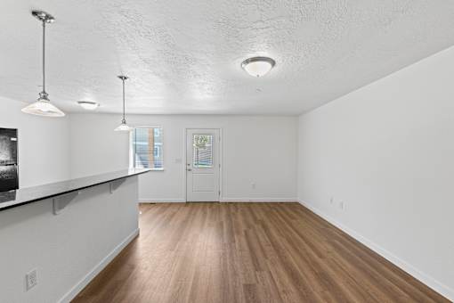 A room with white walls and wooden flooring.