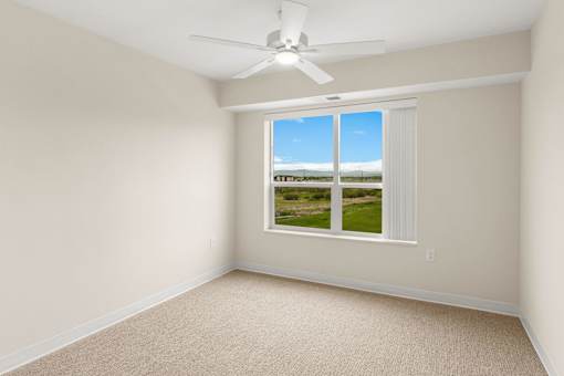 A room with a window overlooking a field at The Beaumont Apartments, Bozeman