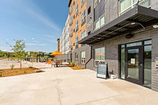 A modern building with a glass door at The Beaumont Apartments, Bozeman