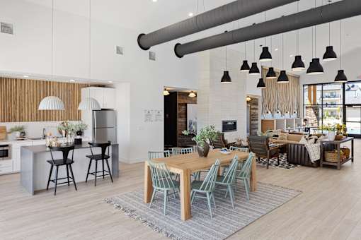 A modern kitchen with a dining table and chairs.
