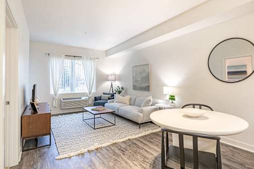 a living room with a couch and a table and a tv at Corso Apartments, Missoula, MT