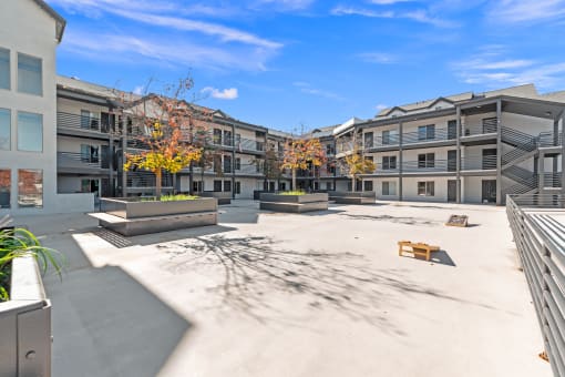 a courtyard with benches and buildings at the apartments at River Walk Apartments, Boise, 83702