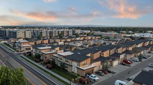A residential area with houses and cars parked on the street. at Verraso Village Apartments, Meridian, Idaho