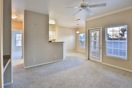 an empty living room with a ceiling fan at The Vineyards of Colorado Springs, Colorado Springs