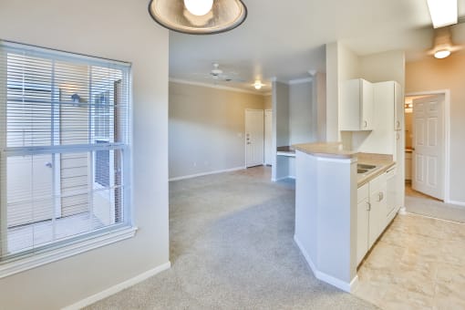a kitchen and living room with a large window at The Vineyards of Colorado Springs, Colorado
