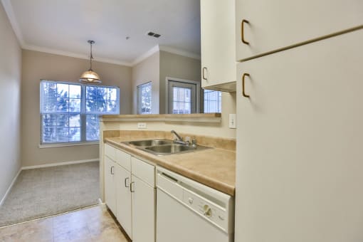 a kitchen with white cabinets and a sink at The Vineyards of Colorado Springs, Colorado Springs, Colorado