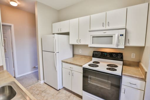 a kitchen with white cabinets and stainless steel appliances at The Vineyards of Colorado Springs, Colorado Springs, 80920