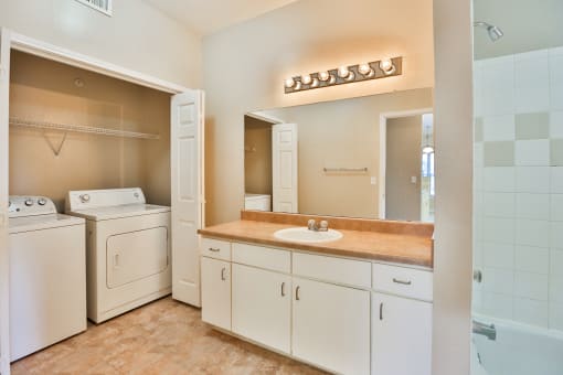 a bathroom with a sink and a washer and dryer at The Vineyards of Colorado Springs, Colorado, 80920