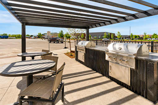 A patio with a table and chairs at The Beaumont Apartments, Bozeman, 59715