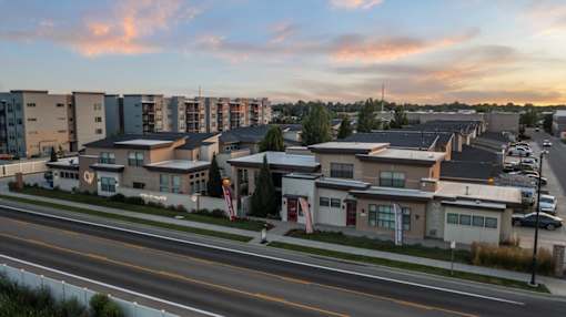 A street view of a residential area with houses and apartment buildings. at Verraso Village Apartments, Idaho, 83646