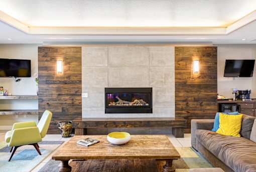 a living room with a fireplace and a coffee table at Corso Apartments, Missoula, MT
