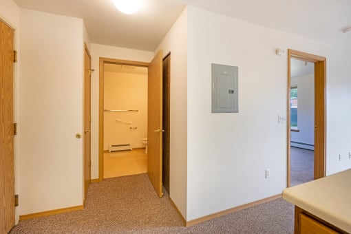 a bedroom with a door to a bathroom and a closet