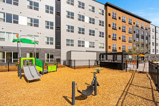 A playground with a green slide and a yellow slide at The Beaumont Apartments, Bozeman, Montana 59715