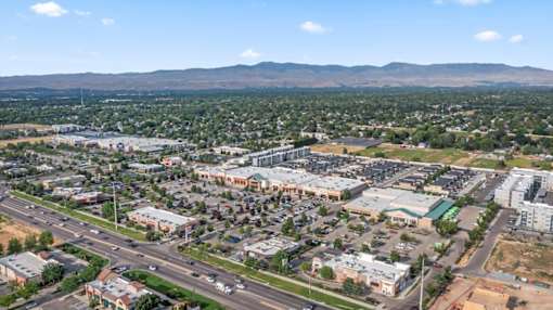 A cityscape with buildings and roads under a clear sky. at Verraso Village Apartments, Meridian 83646