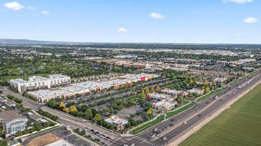 A cityscape with roads and buildings under a clear sky. at Verraso Village Apartments, Meridian