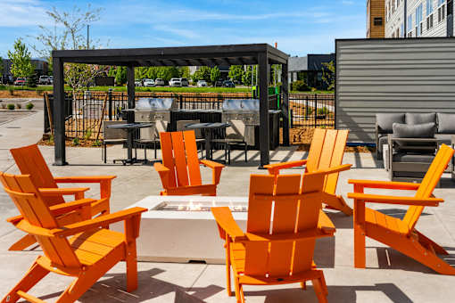 A set of orange chairs and a table at The Beaumont Apartments, Bozeman, MT