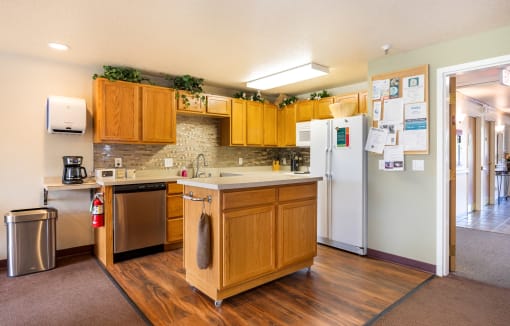 a kitchen with wooden cabinets and a sink and a refrigerator