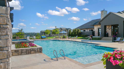a swimming pool with a house in the background at The Vineyards of Colorado Springs, Colorado Springs, 80920