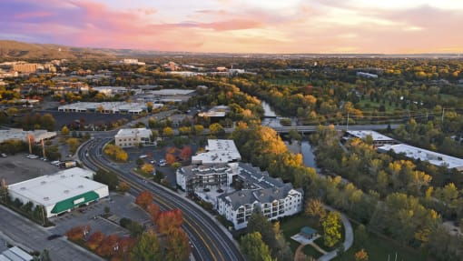 an aerial view of a city with a river and buildings at River Walk Apartments, Boise