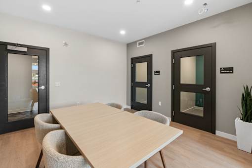 A conference room with a long table and chairs at The Beaumont Apartments, Bozeman, 59715