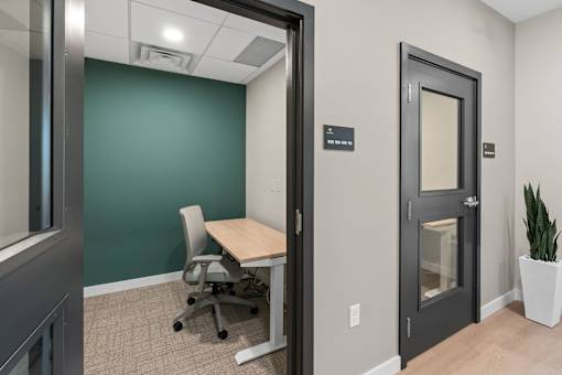 A room with a green wall and a white chair at The Beaumont Apartments, MT 59715