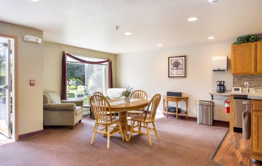 a dining area with a table and chairs in a living room