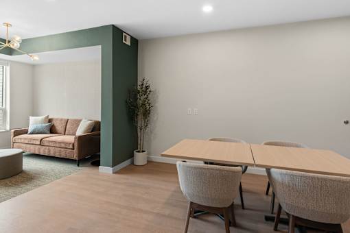 A room with a couch, chairs, and a table at The Beaumont Apartments, Bozeman, MT