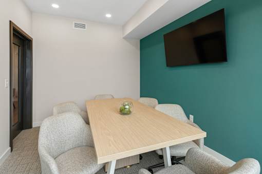 A conference room with a long table and chairs at The Beaumont Apartments, Montana, 59715