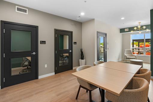 A conference room with a long table and chairs at The Beaumont Apartments, MT 59715
