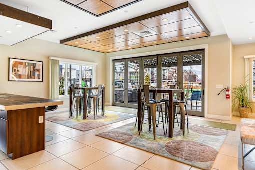 a dining room with a table and chairs in front of a window at Corso Apartments, Missoula, MT