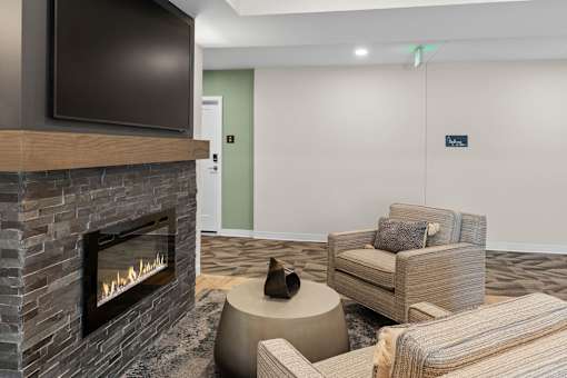 A living room with a fireplace and a couch at The Beaumont Apartments, Montana
