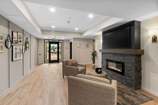 A living room with a fireplace and a television at The Beaumont Apartments, Montana, 59715