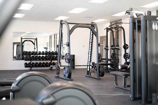 A gym with a variety of equipment including weights and weight machines.at Copestone Apartments, Garden City, ID 59808