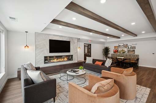 A modern living room with a fireplace and a flat screen TV.