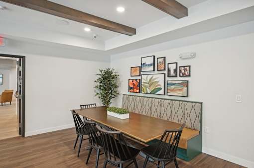 A dining room with a wooden table and chairs.