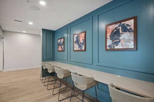 A room with blue walls and a row of chairs.