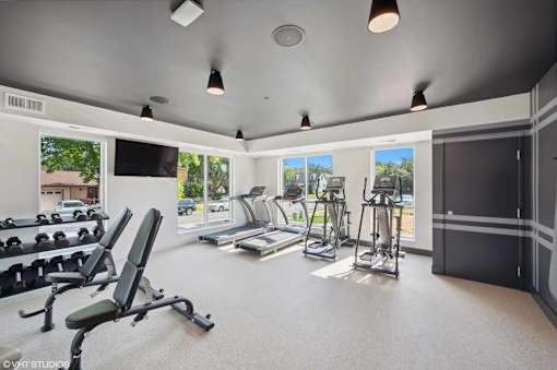 A spacious home gym with a variety of exercise equipment.