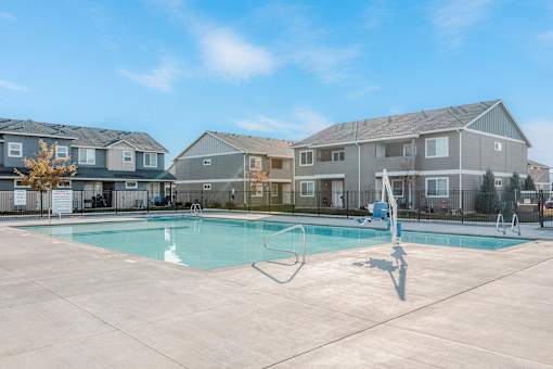 a swimming pool with apartment buildings in the background