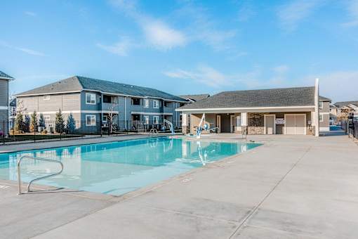 our apartments have a swimming pool with a building in the background