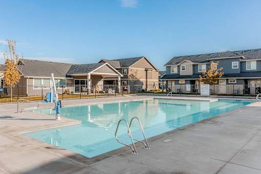 a swimming pool with apartments in the background